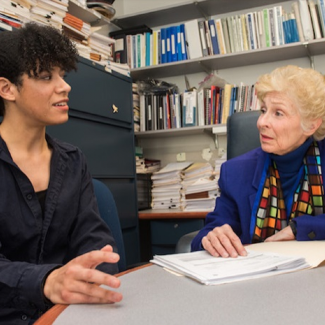 Two faculty members in an office having a discussion