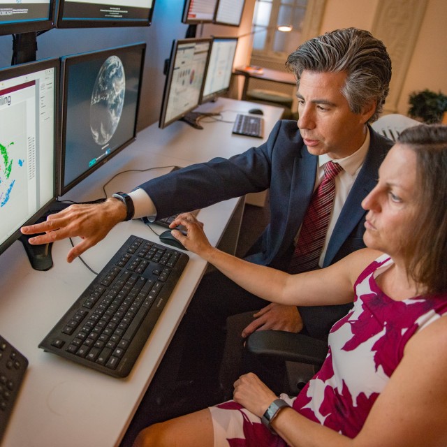 Sam Volchenboum at a computer screen with a student